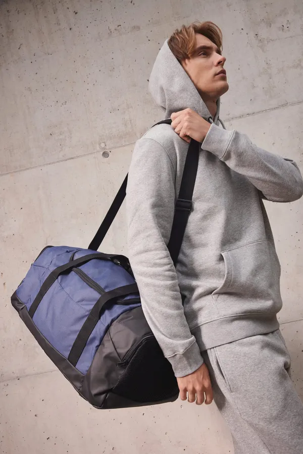 Recycled sports bag with dual side compartment