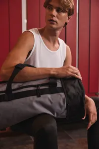 Tubular sports bag with separate shoe compartment